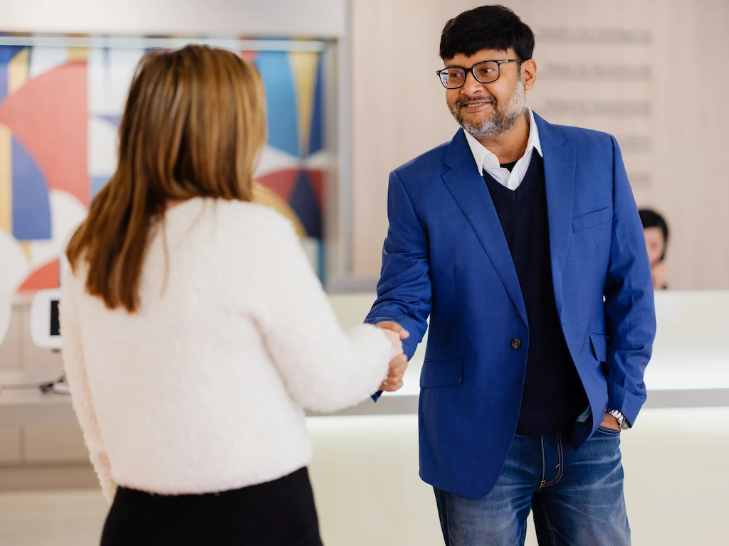 Consultant welcoming client with handshake as part of a fractional CFO service and CFO strategy engagement in India