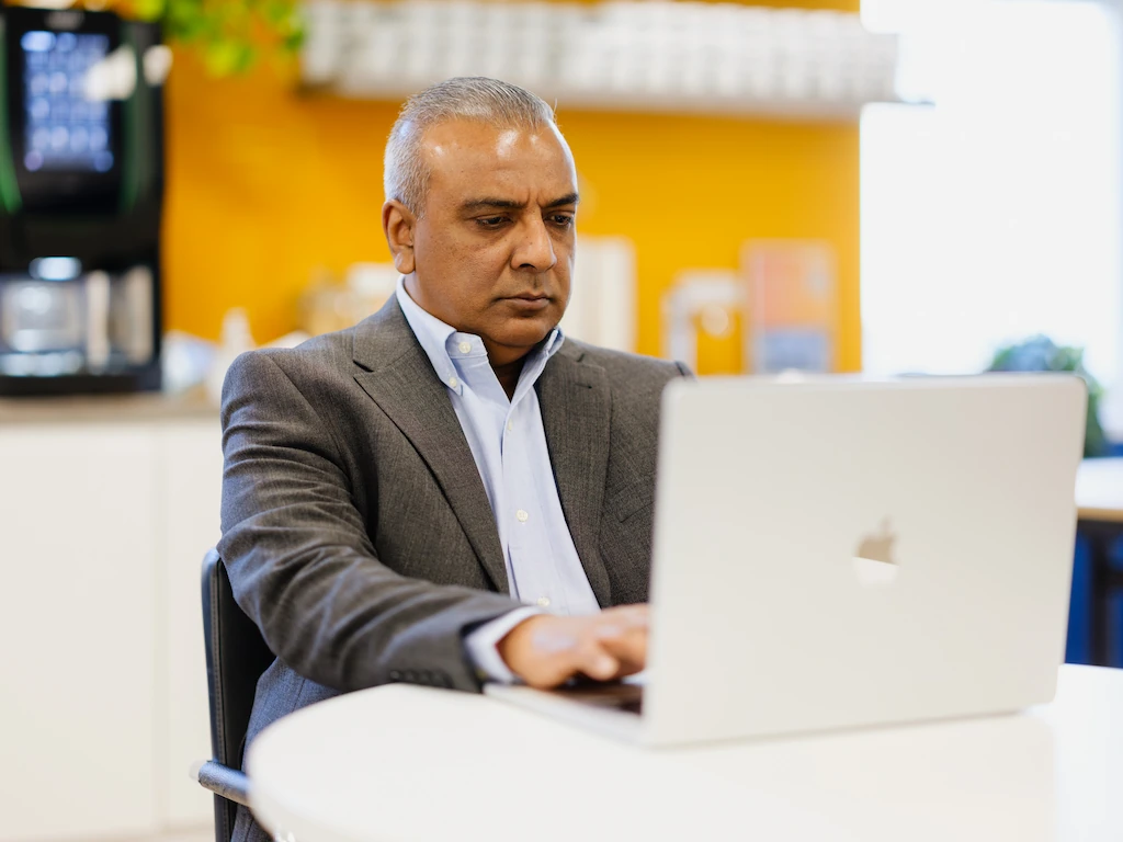 Professional reviewing financial data on laptop during a fractional CFO India engagement focused on CFO strategy and performance analysis